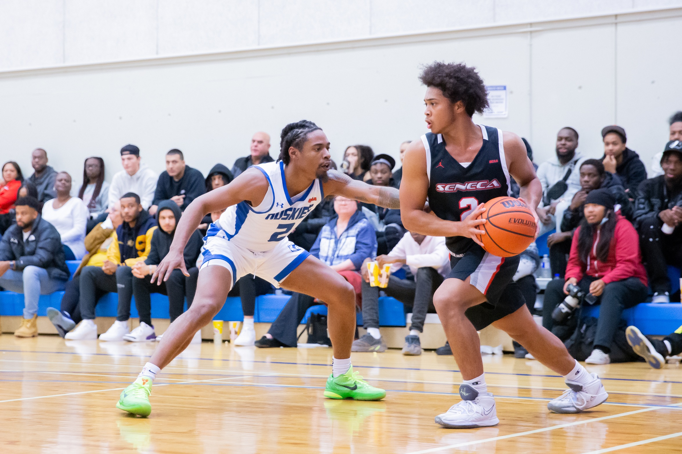 Huskies defender guards ball against Seneca player