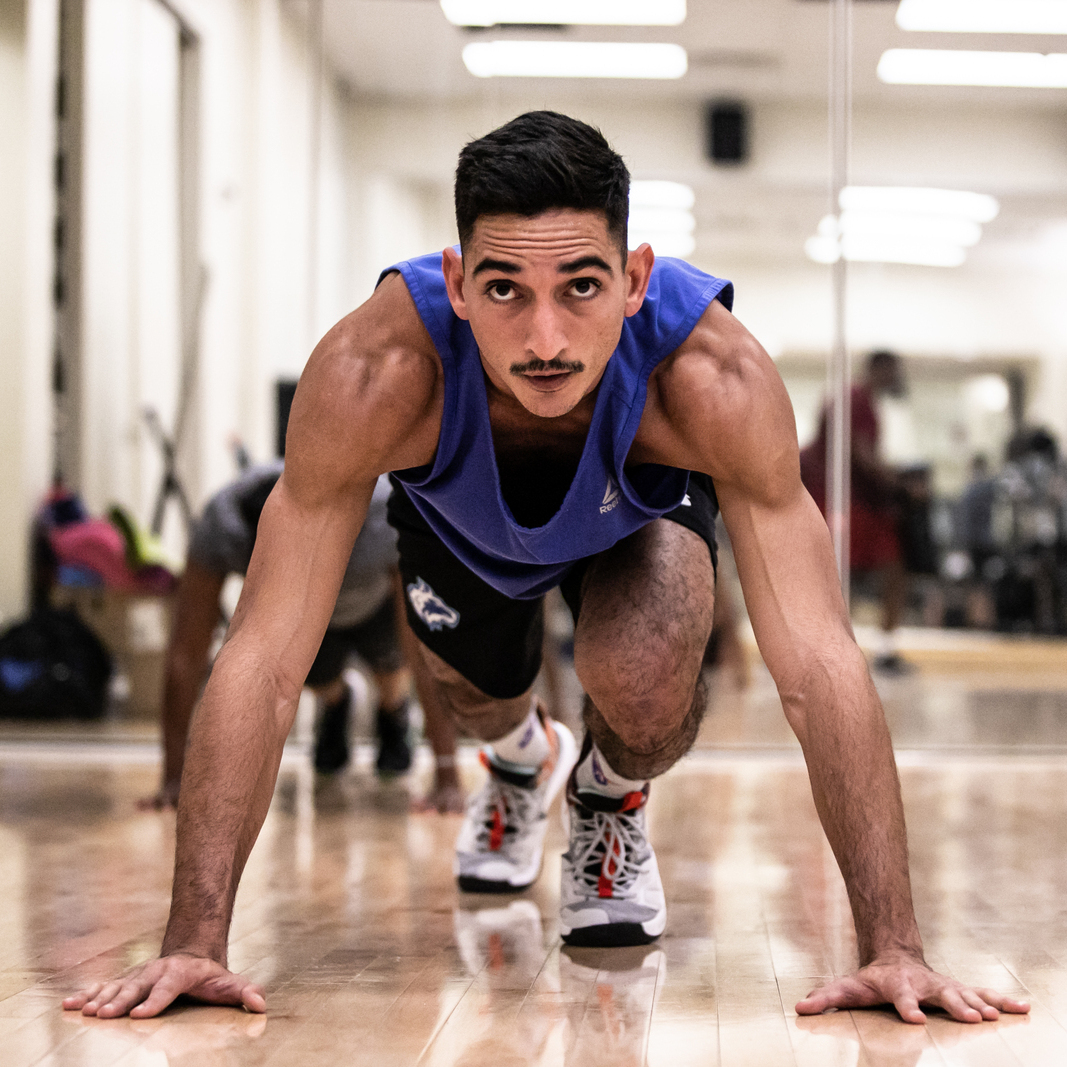 Male Cardio Combat fitness class participant doing push up