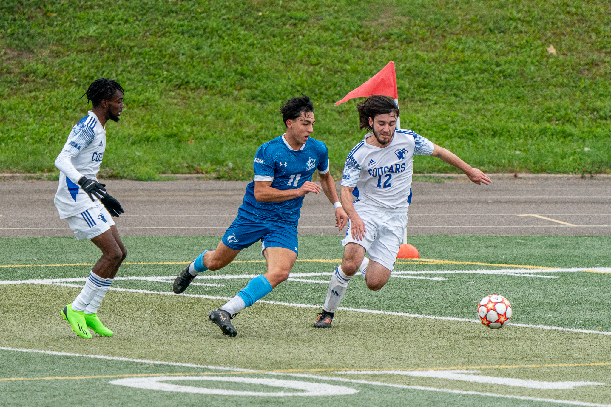 Huskies #11 and Sault Cougars #12 battle for the ball