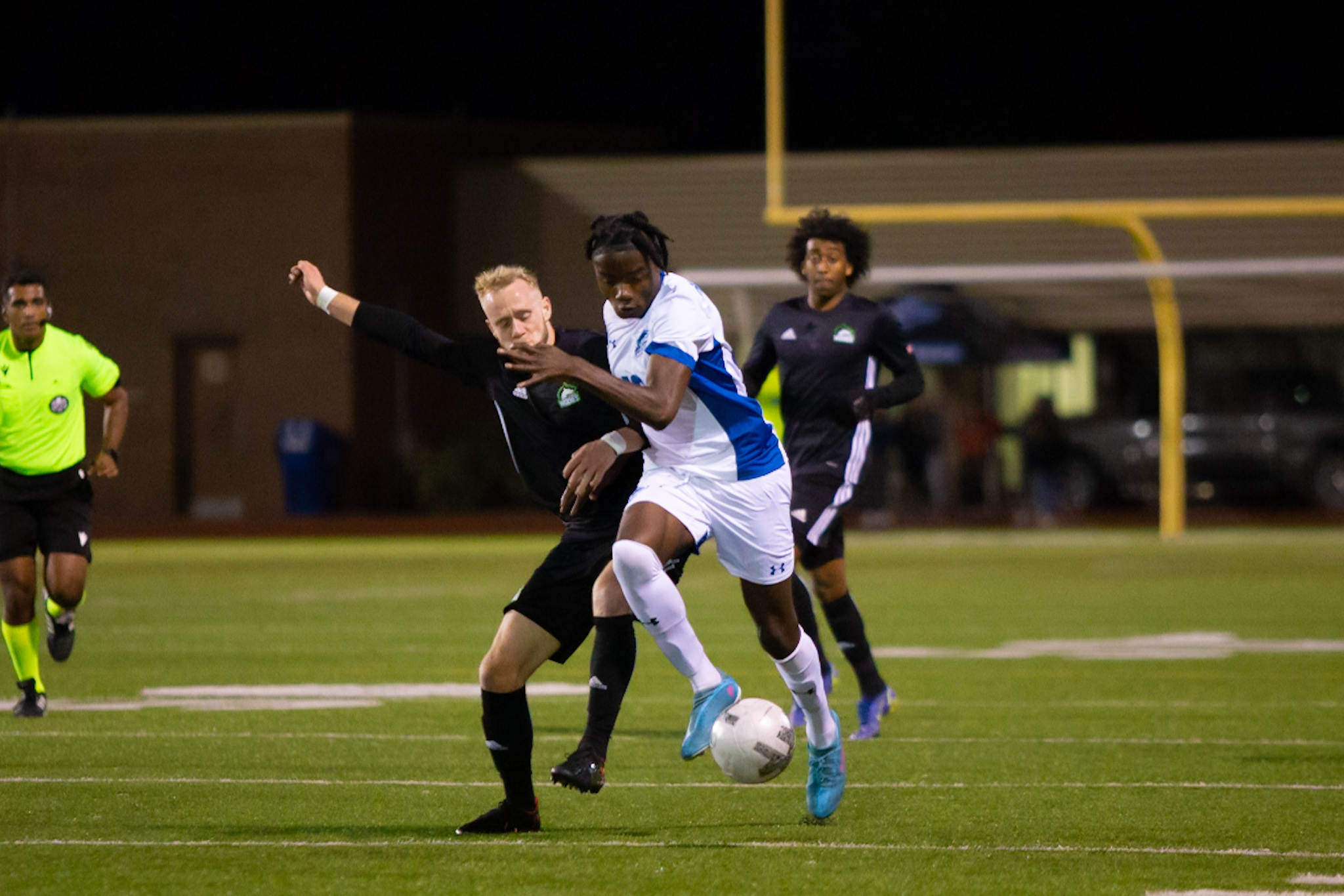 Huskies player and Wolves player battle for ball
