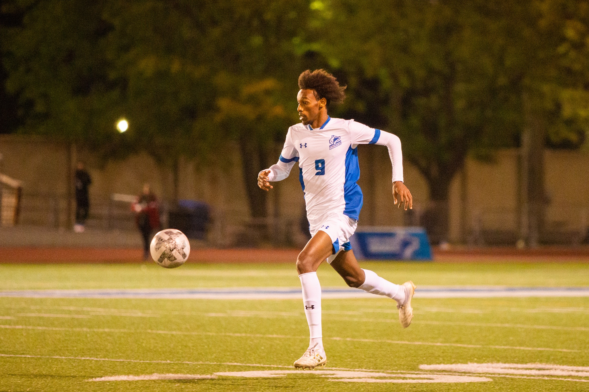 Huskies #9 dribbles ball up field