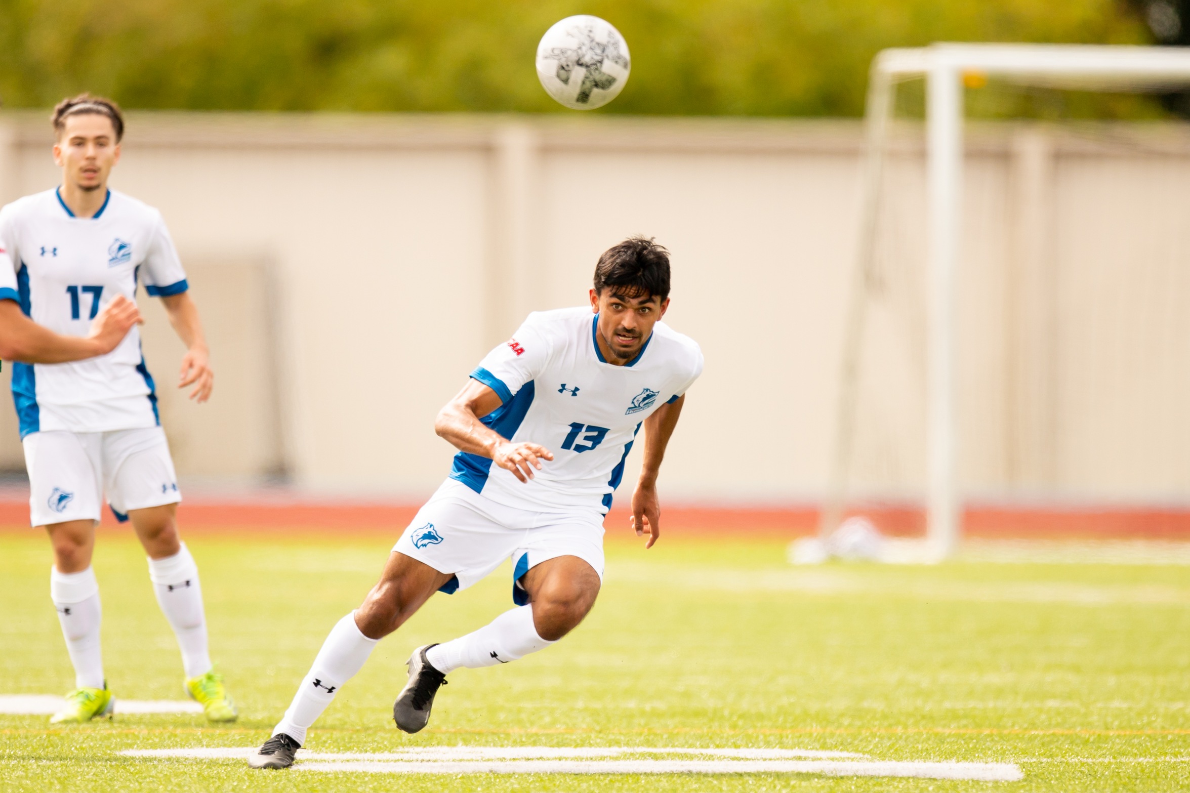 Huskies #13 heads the ball forward