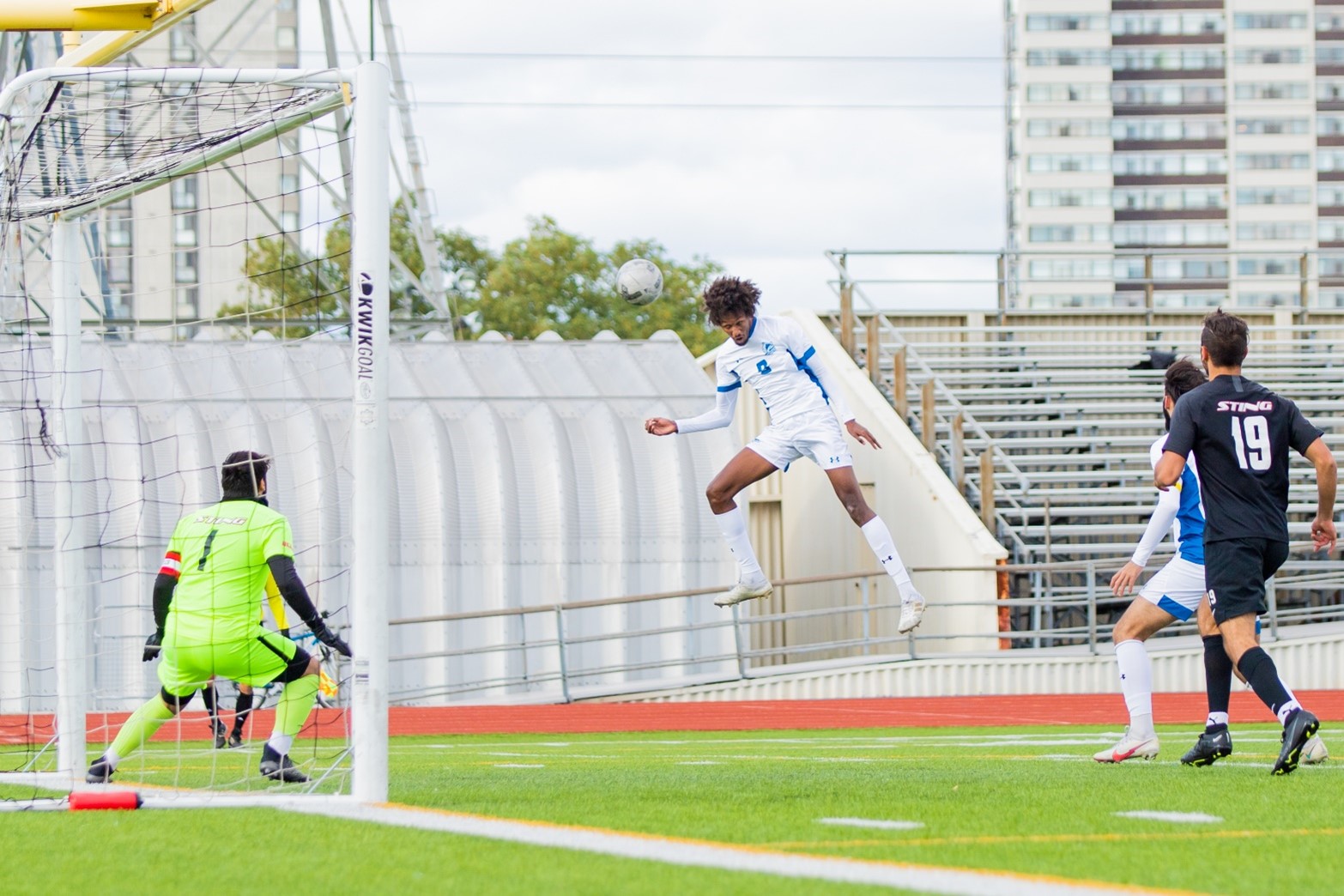 Huskies #9 yonis jama heads ball towards goalkeeper