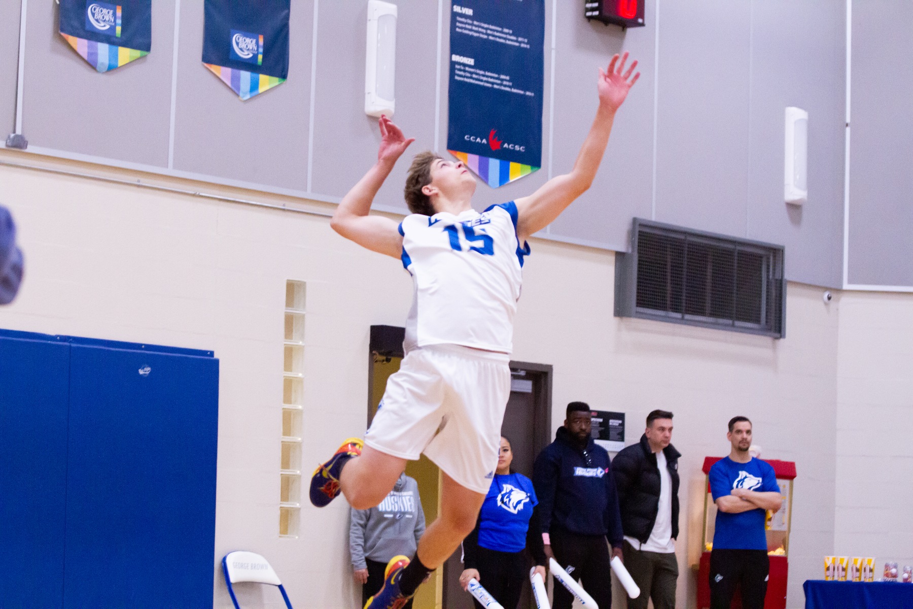 Volleyball player Grayson Engleman hits a jump-serve