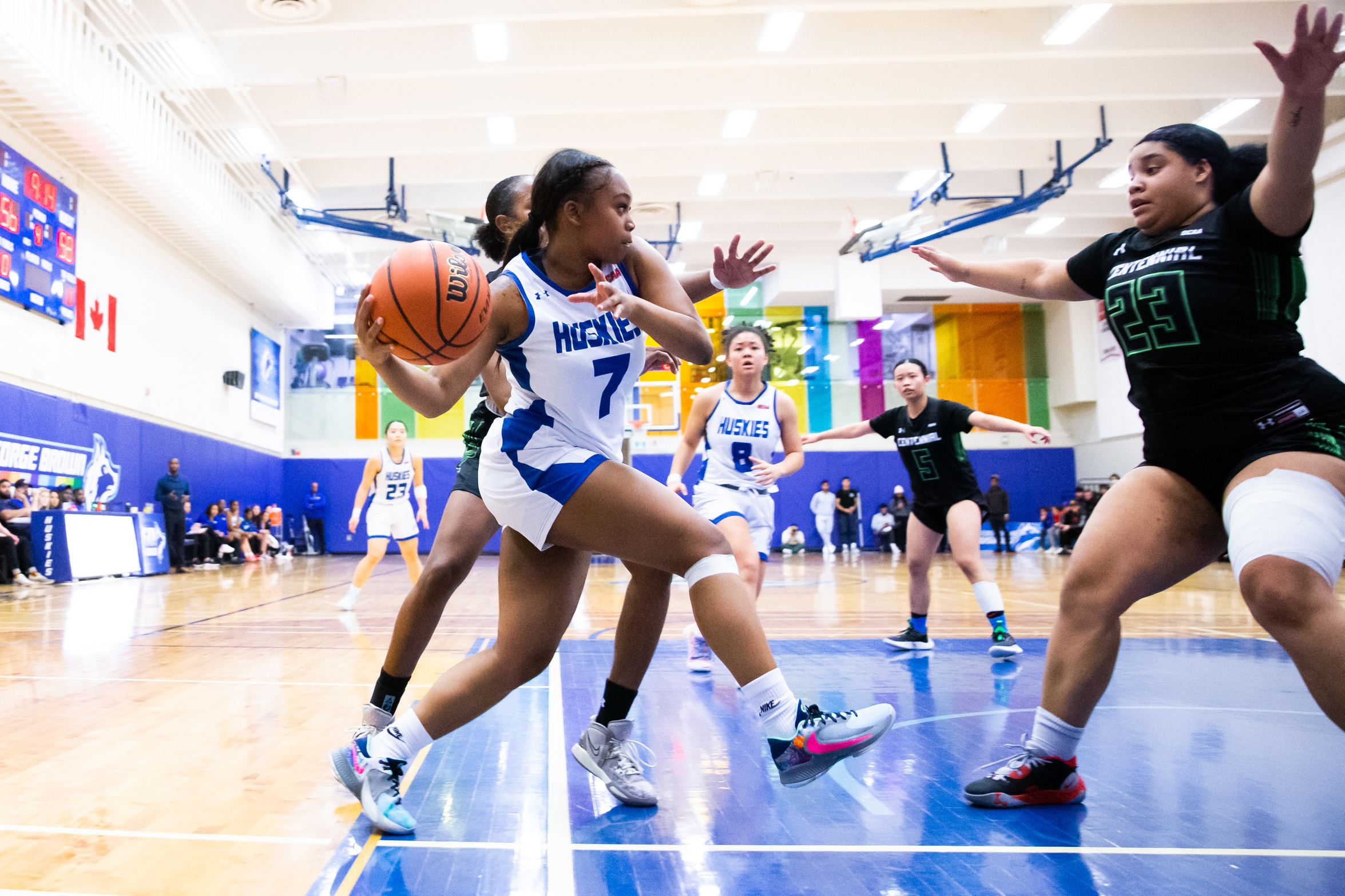 Huskies #7 drives on the baseline looking to pass ball