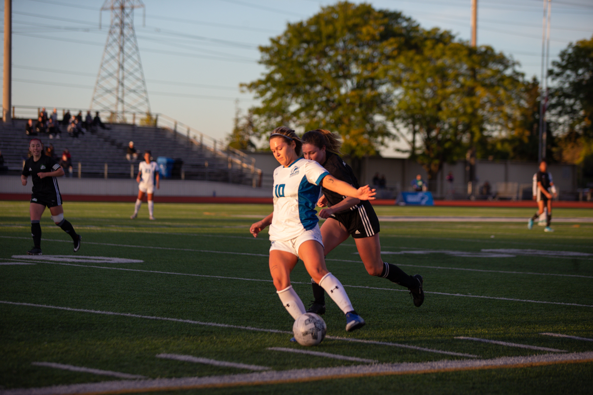 Huskies #10 Cynthia Pellegrino shields the ball against Algonquin Wolves player