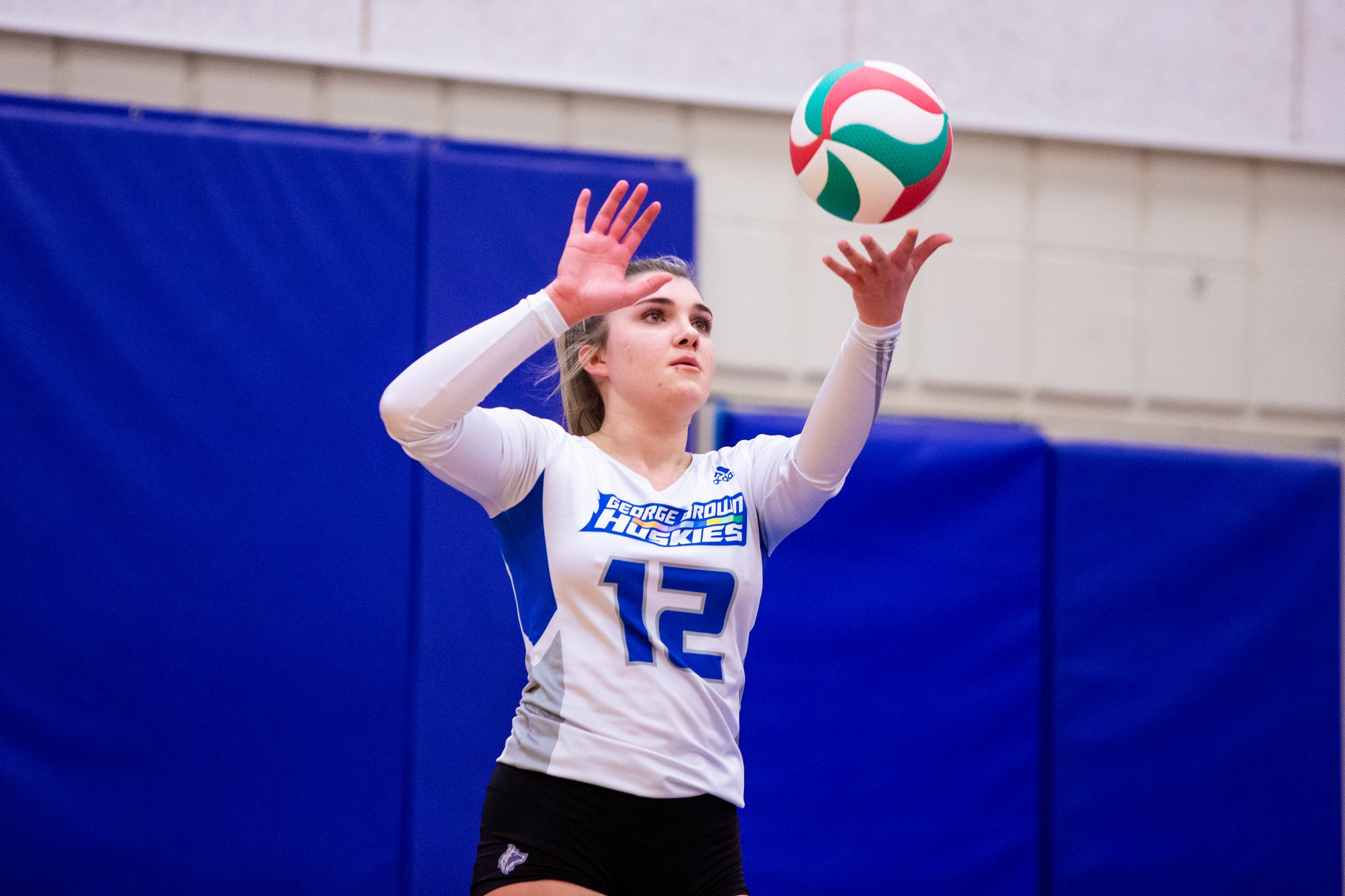 Women's volleyball player Megi Memcaj holds ball to serve